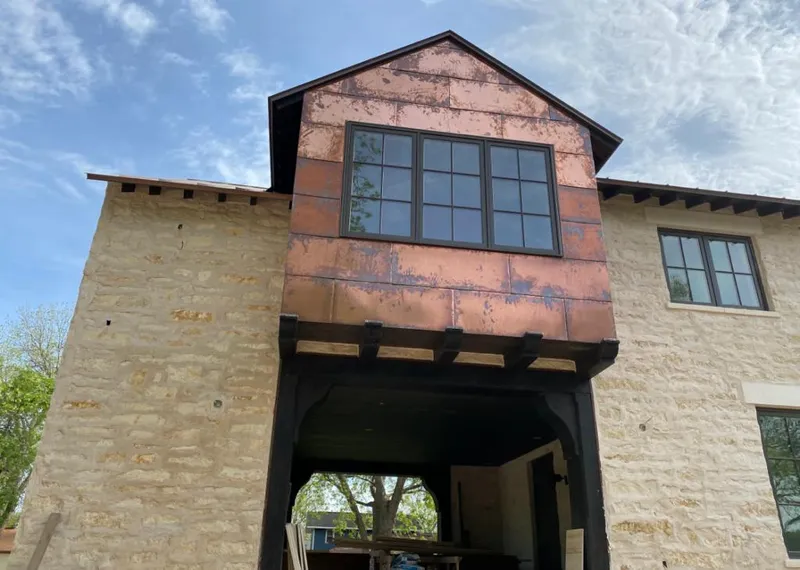 Copper metal panel facade on a stone building for Metal Roof Coating in Gardendale