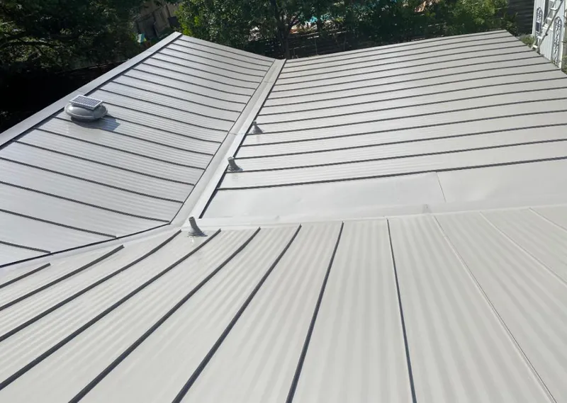 Solar attic fan installed on a metal roof for Roof Ventilation in Gardendale